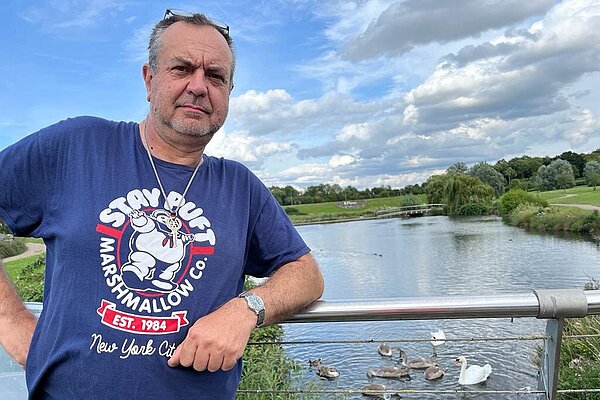 Scott Henderson standing on a bridge over the river Ouse