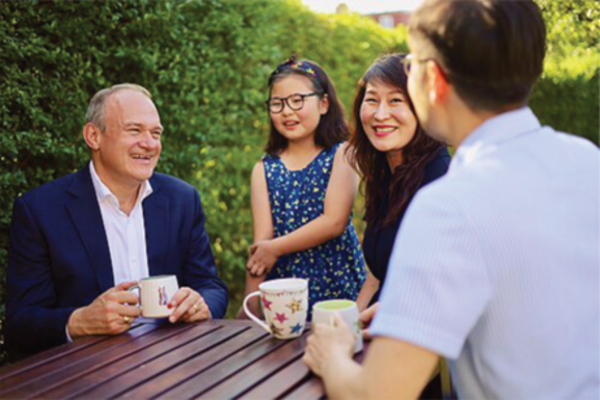 Ed Davey around a table other people