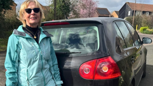 Cllr Marie Bradburn next to car parked partly on pavement