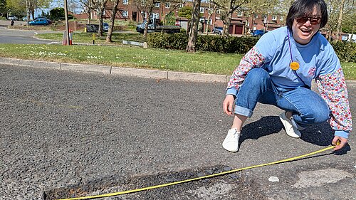 Emily Ho measures pothole