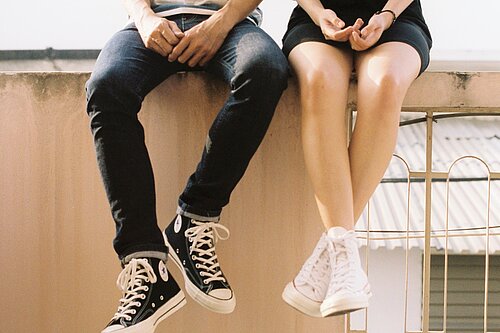 Young people sitting on a wall